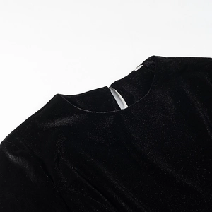 Close-up of black sparkly velvet top showing round neck and keyhole back detail