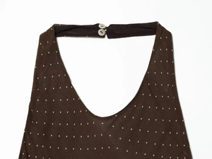 Detail of V-neckline on brown polka dot dress with two pearl buttons on back collar