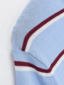 Detailed close-up showing the precise shoulder seam and striped knit texture of the top