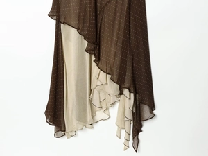Detail of asymmetrical tiered skirt with coffee and beige polka dot ruffles and soft drape