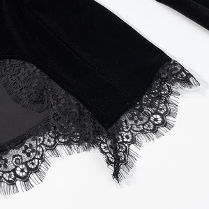 Macro view of black velvet fabric with delicate floral eyelash lace trim on the garment