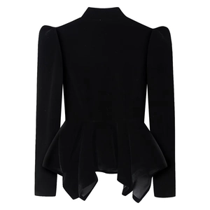 Detailed view of black velvet peplum top with puffed shoulders and elegant hollow-out design