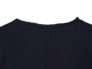 Detailed close-up of dark navy woven top featuring intricate lace trim on the neckline