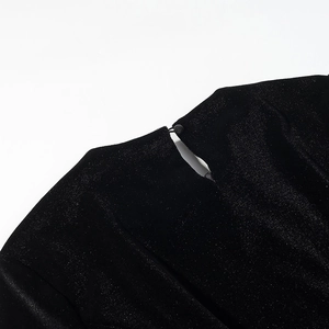 Detail of black velvet blouse featuring glitter star finish and back waterdrop cutout