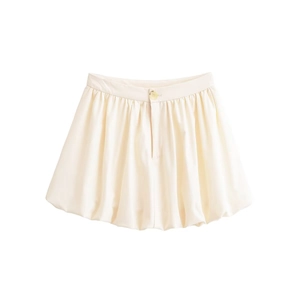 Détail de la jupe bulle blanc crème avec taille plissée et élégant bouton doré