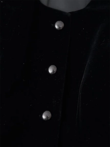 Detail of silver hemispherical metal buttons on a black velvet elegant jacket fabric