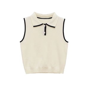Close-up of contrast black piping on the polo collar and armholes of an off-white knit vest