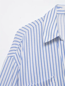 Detail of blue and white striped shirt collar with dropped shoulder and fabric texture