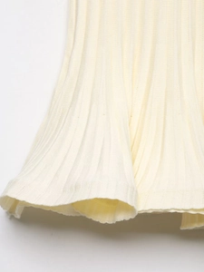 Detail view of cream ribbed knit fabric showing vertical texture and stitching quality