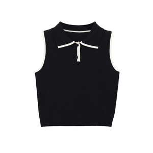 Close-up detail of knitted polo vest with white contrast trim and black buttons