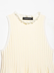 Detail of light yellow ribbed knit tank top with delicate ruffled neckline texture