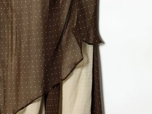 Detail of layered chiffon fabric with brown and beige polka dot patchwork design