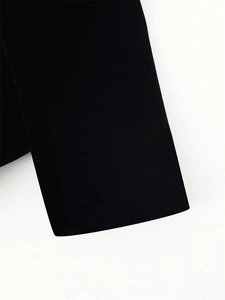Detailed macro view of premium black velvet fabric texture and bubble sleeve cuff detail