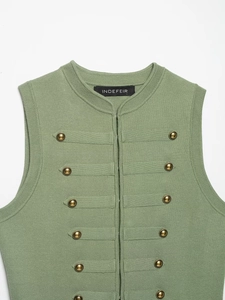 Detail of sage green knit vest featuring vintage gold buttons and ribbed texture edges