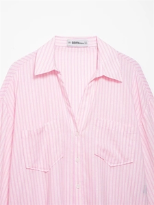 Close-up of pink and white striped shirt with lapel collar, buttons and chest pockets