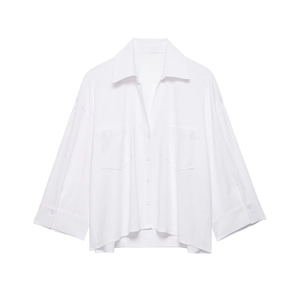 Detail showing white button-down shirt with wide lapels and symmetrical chest pockets