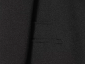 Detail of high-quality double-welt pocket on a black blazer with precise stitching
