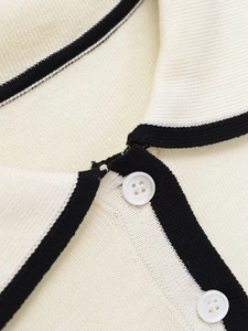 Close-up of knit polo vest showing contrast trim collar and fine button detailing