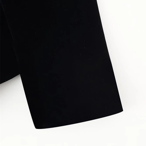 Elegant black velvet jacket featuring chic puff sleeves and a sophisticated cutout design