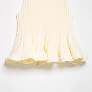 Sleeveless rib-knit top in beige with pleated ruffle hem and textured fabric detail