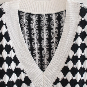 Chic black and white checkered V-neck knit vest with soft texture and ribbed collar