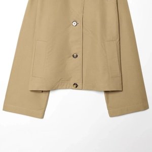 Fashionable khaki cropped trench coat with textured buttons and large pockets
