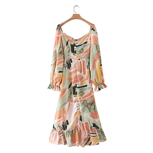 Detail view of abstract colorful print and ruffle hem on long sleeve midi dress