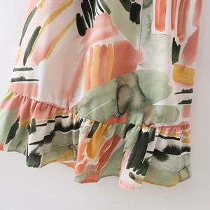 Abstract watercolor print dress with ruffle hem detail and lightweight fabric texture