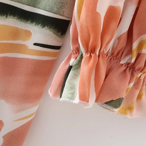 Detail of ruffle cuff and abstract floral print on lightweight summer dress