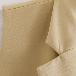 Detail of camel notched lapel and twill fabric texture on the sleeveless vest