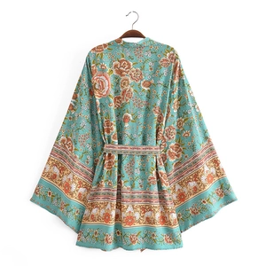 Detail view of Bohemian floral rayon kimono cardigan with large rose prints and a waist belt