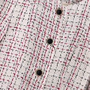 Classic tweed jacket for women featuring white and pink woven fabric with gold-rimmed buttons