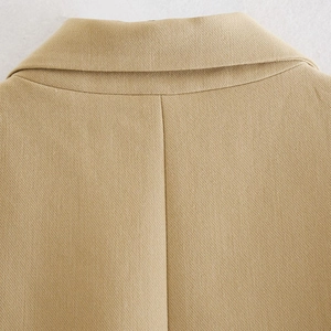 Close-up of khaki vest back collar and central seam with premium woven texture