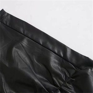 High waisted black PU leather skirt featuring elegant ruffle details and textured finish