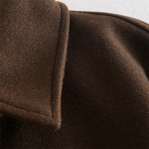 Detailed macro shot of dark brown wool blend shirt jacket with premium stitching