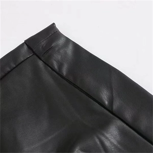 Close-up of black faux leather high waist skirt featuring ruffles and neat stitching