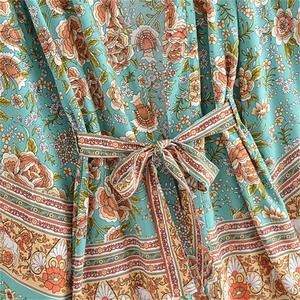 Close-up of Bohemian floral print fabric with tie-waist detail on a long-sleeve cardigan