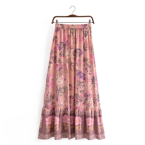 Detail view of pink floral maxi skirt with elastic waist and wide tiered patterned hem