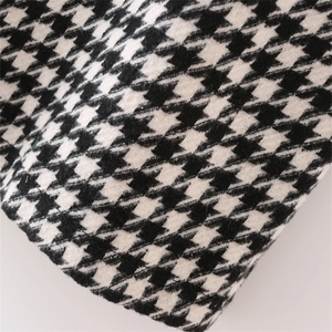 Close-up of black and white houndstooth fabric showing thick woven texture and detail