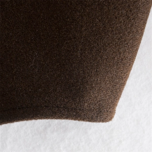 Close-up of brown wool-like fabric texture showing flat seams and high-quality stitching