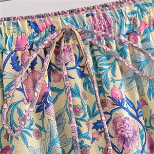 Detail of high waist elastic waistband with drawstring on floral print maxi skirt