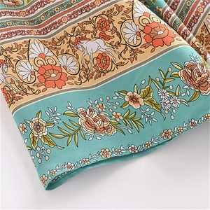 Detail of bohemian floral print and horse pattern on rayon kimono dress fabric