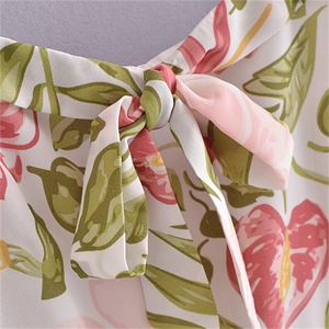 Detailed macro shot of French style floral print chiffon with a delicate bow tie strap