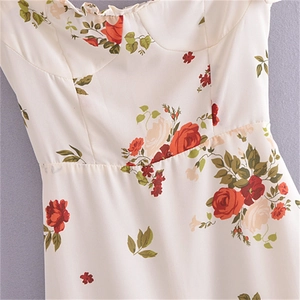Detail view of French vintage floral dress showing red rose print and ruffled neckline trim