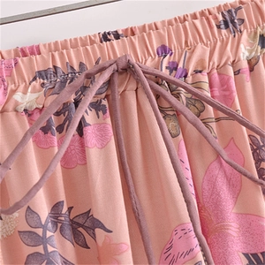 Detail of pink floral cotton skirt featuring elastic waistband and drawstring tie