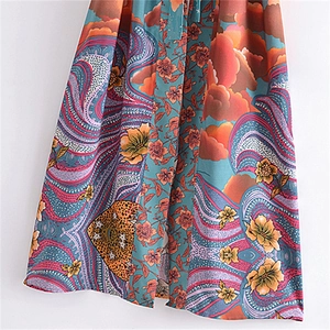 Detail of bohemian floral and paisley print fabric with vibrant turquoise and orange tones