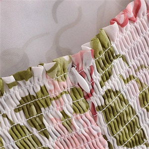 Detail of floral smocked fabric with a concealed white zipper on the back of the dress