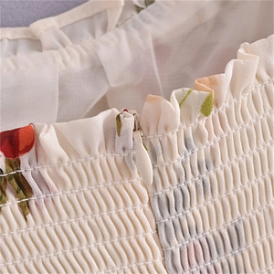Detailed close-up of the vintage floral dress showing shirring and invisible zipper