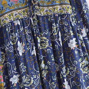 Macro detail of blue floral viscose dress featuring ethnic print and beaded tassel drawstring