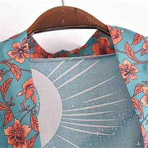 Detailed view of the neckline and floral print on a blue bohemian cardigan robe
